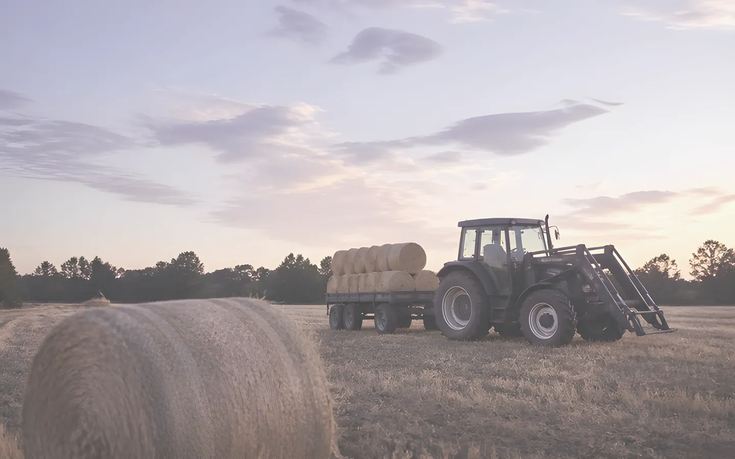 Tractor and hay bales in an Australian paddock