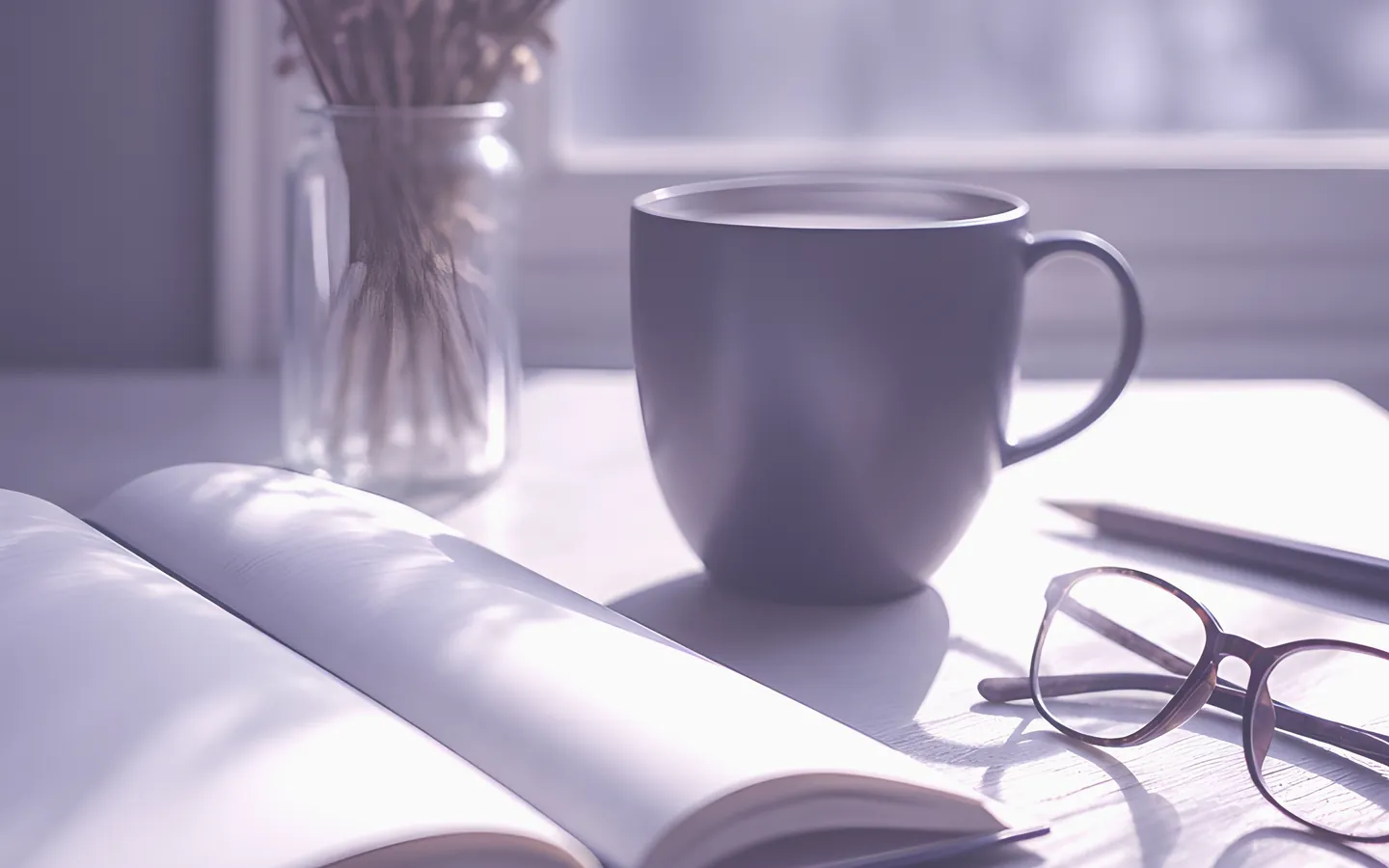 Open notebook, glasses and coffee on a desk