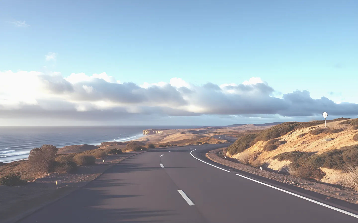 Winding coastal road with changing light